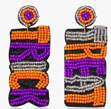 Pair of orange, purple, silver, and black beaded dangle earrings with stacked TRICK lettering.