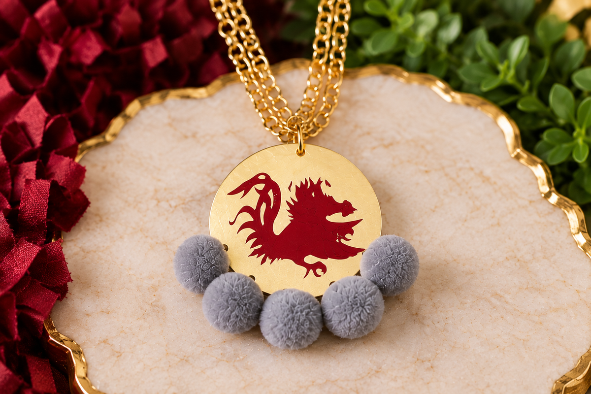 Carolina Gamecock Pom Pom Statement Necklace by Southern Script with Gray pom poms, garnet Gamecock design and matte-gold round pendant.
