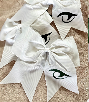 Multiple River Bluff white grosgrain Gator Eye cheer bows displayed together