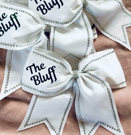 River Bluff white grosgrain cheer bow with silver rhinestone trim and forest green The Bluff lettering – front view