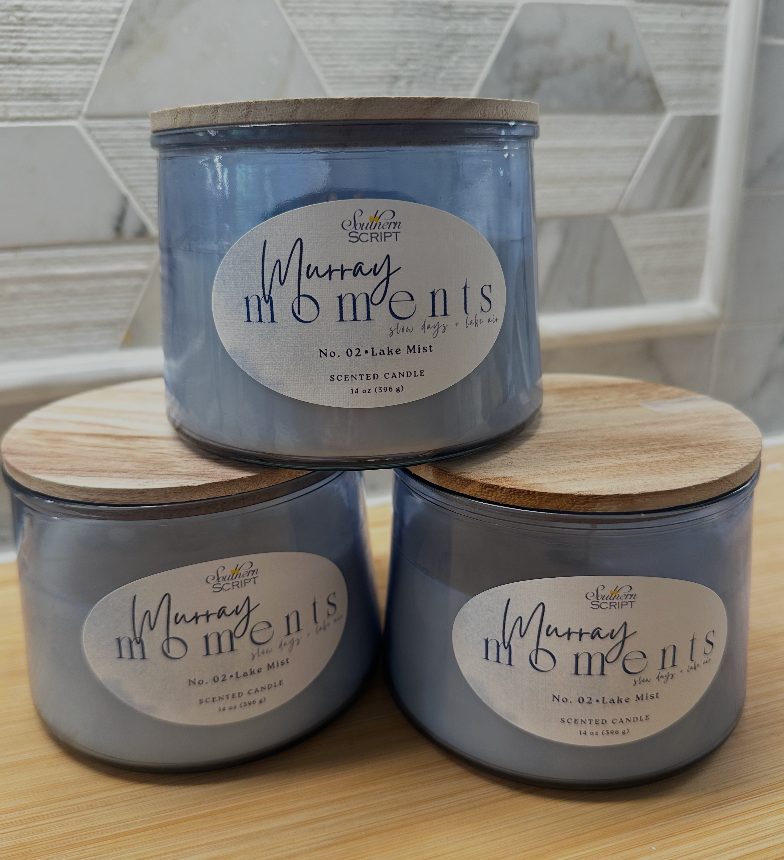Three Murray Moments No. 02 Lake Mist 14 oz candles in blue-tinted glass vessels with light wood lids