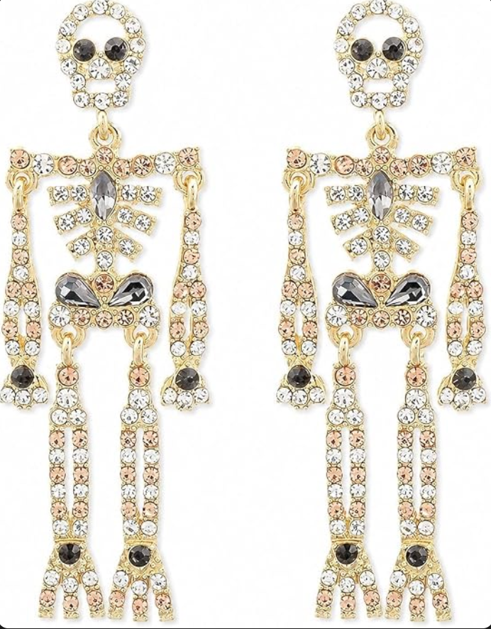 Pair of gold-tone skeleton dangle earrings covered in clear and dark rhinestones on a white background.