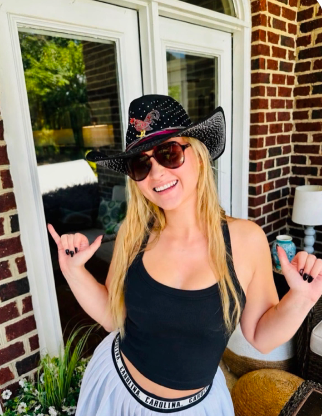 Woman wearing a black rhinestone Carolina Show Stopping Topper with jeweled Gamecock detail and sparkling wide brim.