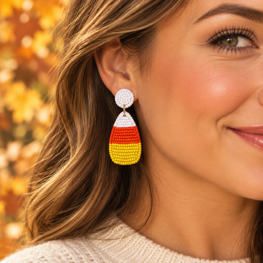 Adult model wearing the candy-corn beaded earrings in a fall setting