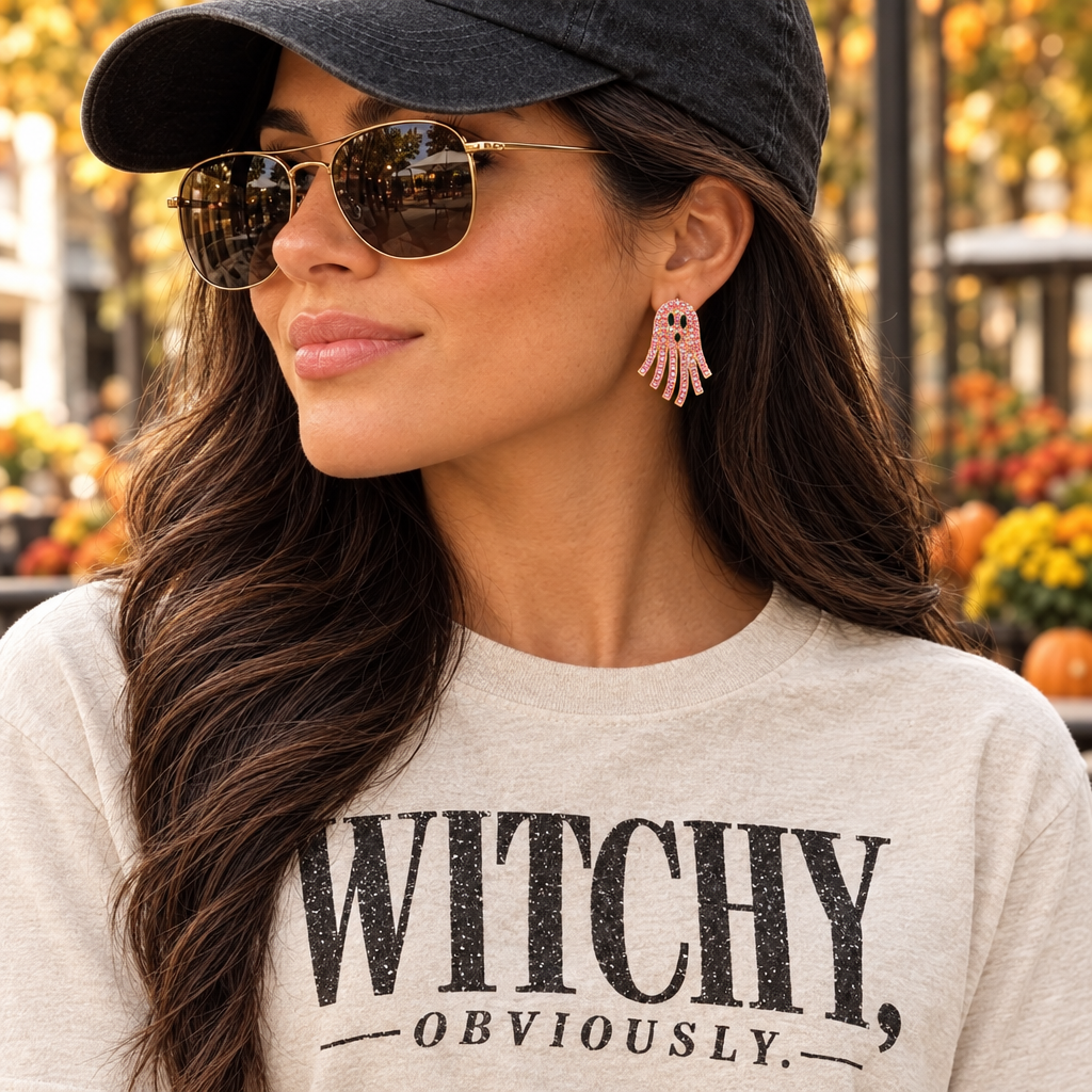 Closer view of the woman wearing the pink ghost earring and Witchy, Obviously. shirt
