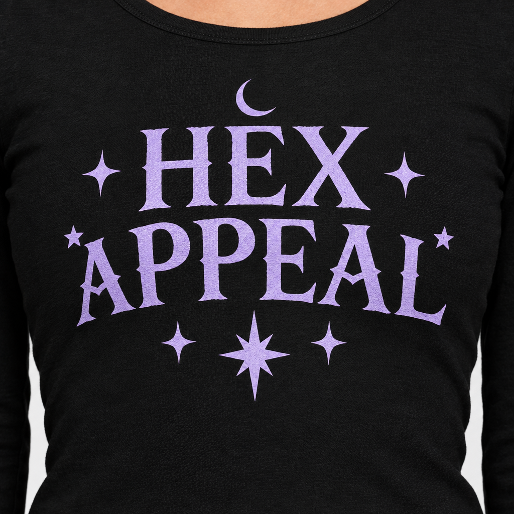 Close-up of the black shirt front with lavender HEX APPEAL lettering, a crescent moon, and stars.