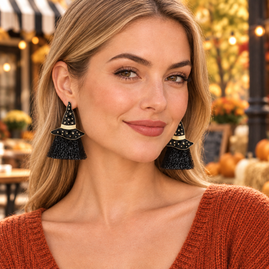Light-haired model wearing Witch, Please! tassel earrings