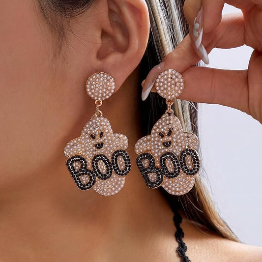 Pale pink pearl-look ghost BOO earrings shown worn, with a close-up of one ear and a hand holding the pair.